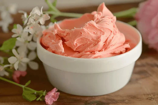 Beautiful swirl of homemade pink Rose Body Butter Go Native NZ recipe in a white bowl with delicate flowers