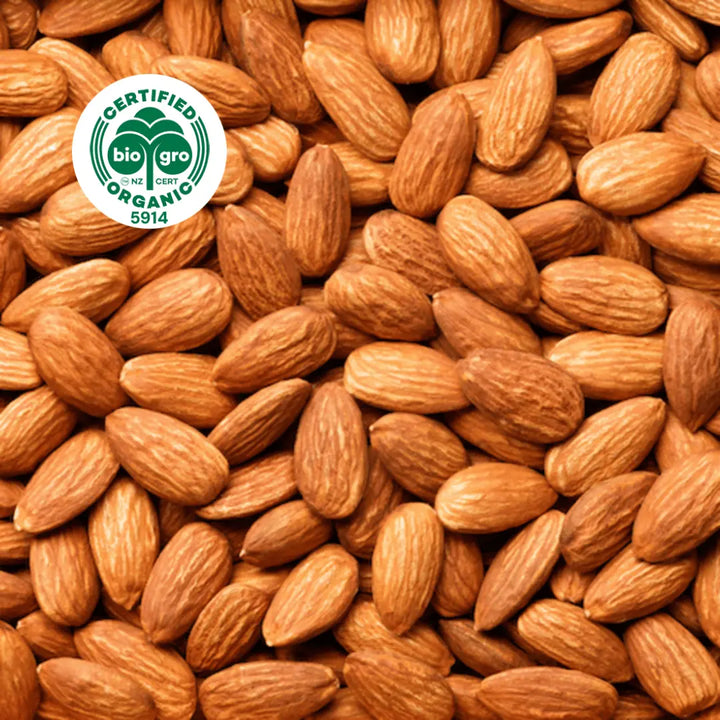 Almond kernels clustered together with bio gro Certified Organic icon to verify Go Native New Zealand's organic certification for sweet almond carrier oil