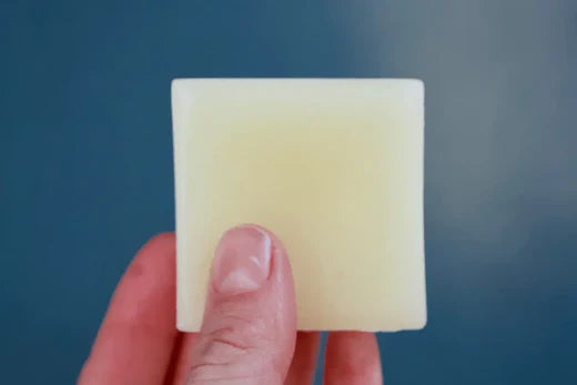 fingers holding solid shampoo bar made from scratch go native nz recipe