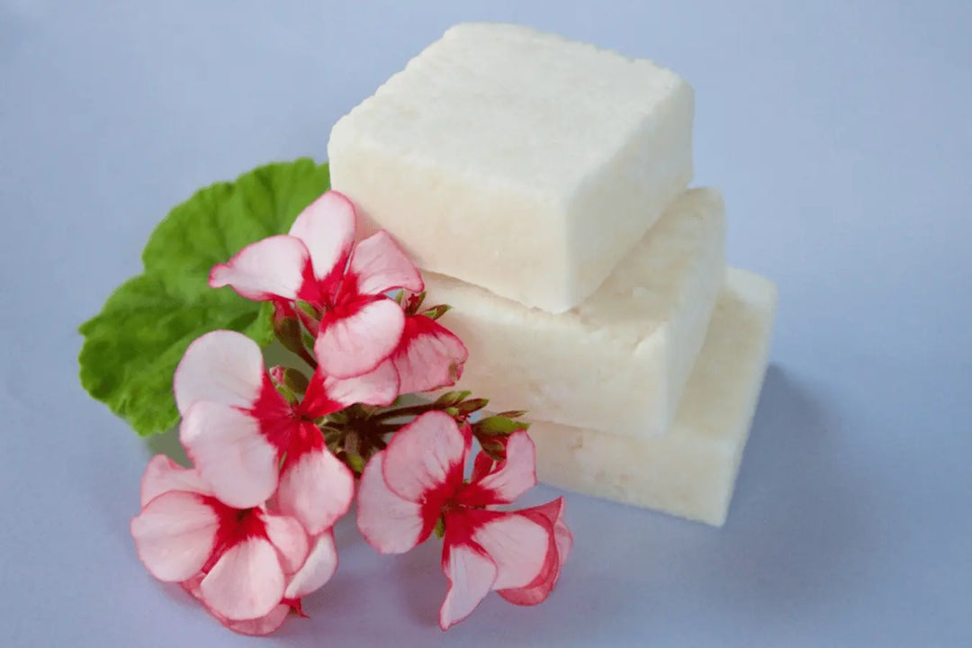 Homemade three white shampoo bars stacked go native new zealand recipe, with geranium flowers 