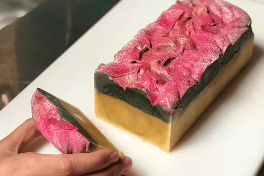 Go Native NZ Kiwi Christmas Pohutukawa Soap CP Recipe on bench with one slice cut showing soap layers
