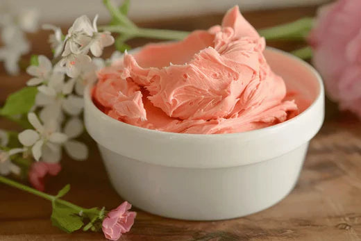 Beautiful swirl of homemade pink Rose Body Butter Go Native NZ recipe in a white bowl with delicate flowers
