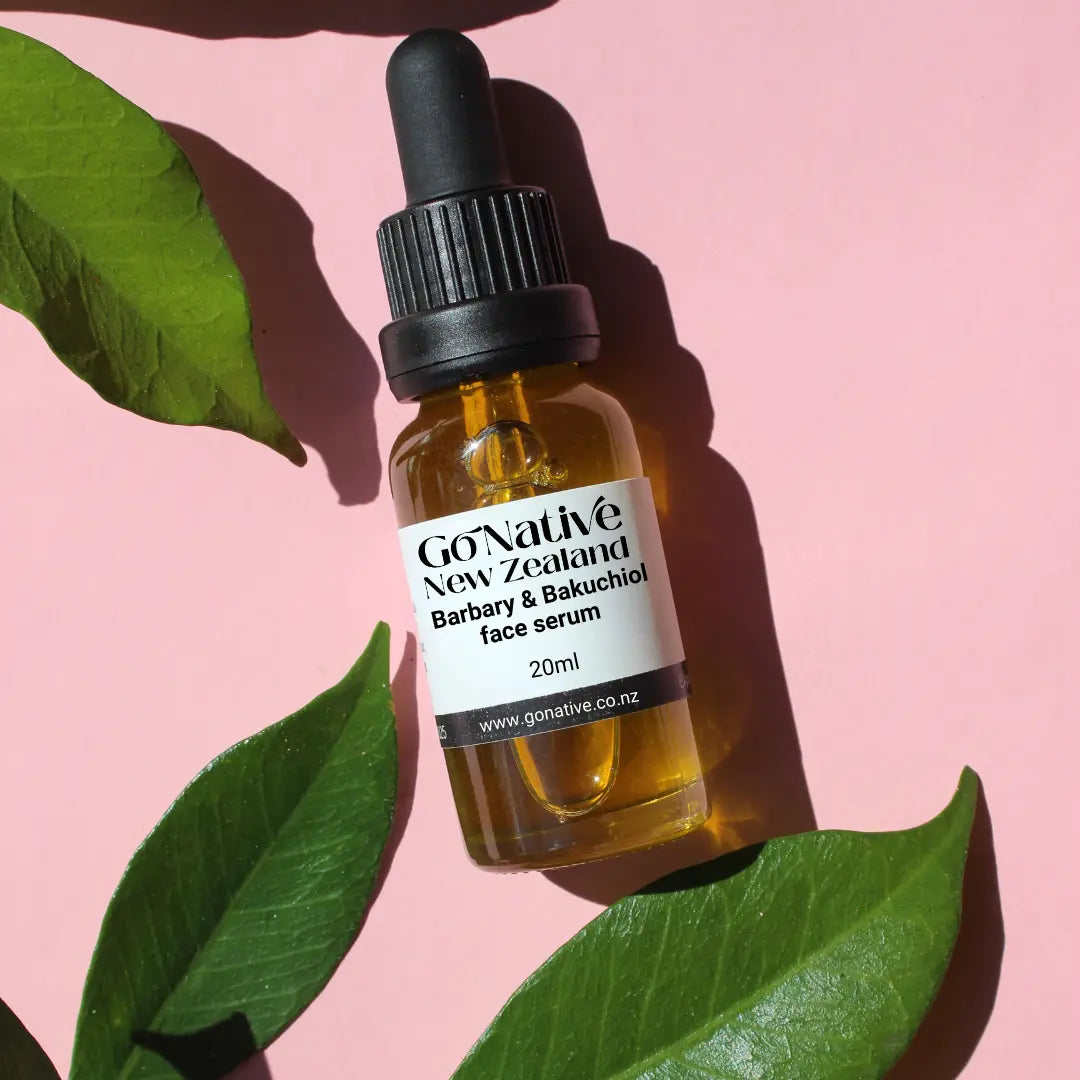 Bottle of GoNative New Zealand face serum with leaves on a pink background