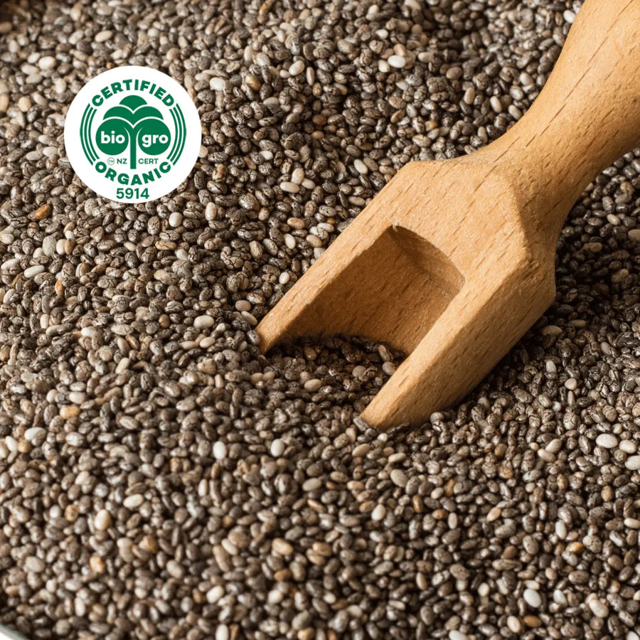 close up of chia seeds with wooden scoop with bio gro Certified Organic icon to verify Go Native New Zealand's organic certification for chia seed carrier oil