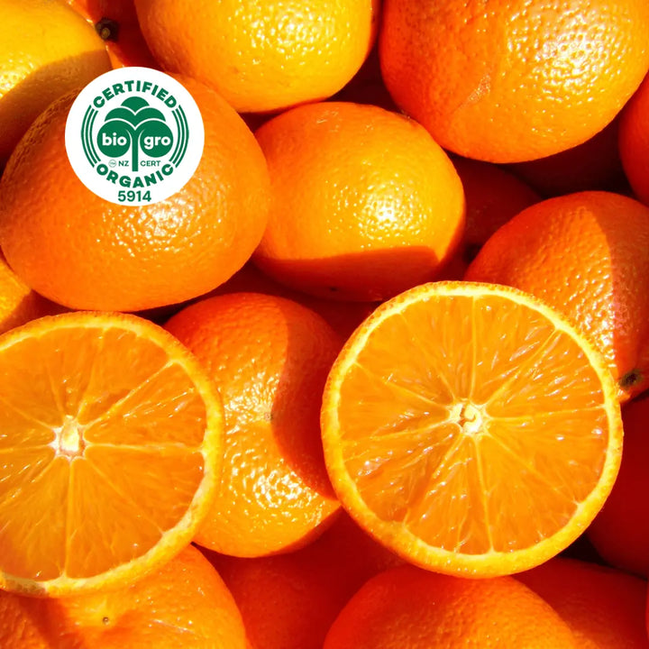 flatlay of oranges with one sliced in half, in bright sunlight to make Go Native NZ Essential Oil with Bio Gro Icon 5194 to verify Certified Organic